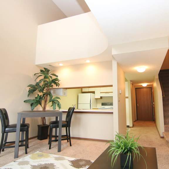 Thumbnail 5 of 13 A living room with a dining table and chairs.