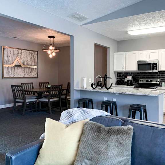 clubhouse lounge space and kitchen with a couch and a table