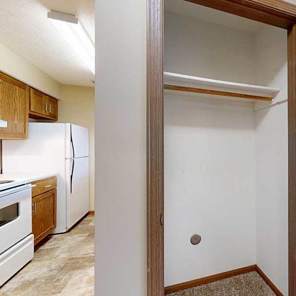 Thumbnail 15 of 29 A closet in the hallway with a built-in shelf, next to the kitchen.