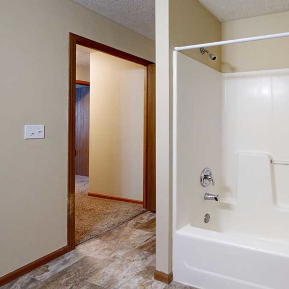 Thumbnail 20 of 20 a bathroom with a white tub shower and a towel rack