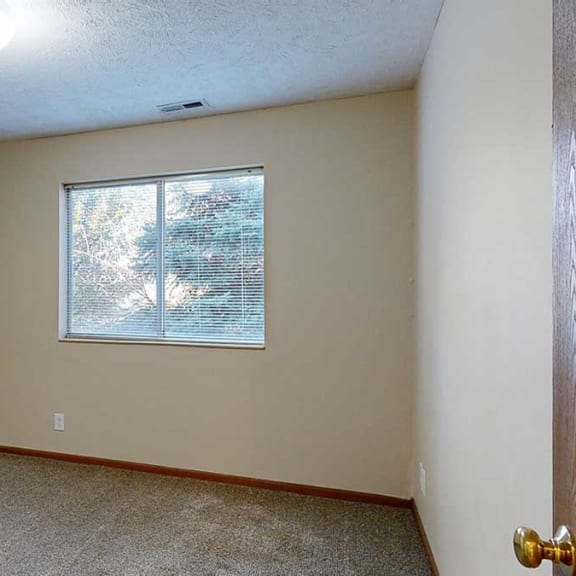 Thumbnail 16 of 20 a bedroom with carpet flooring and a large window