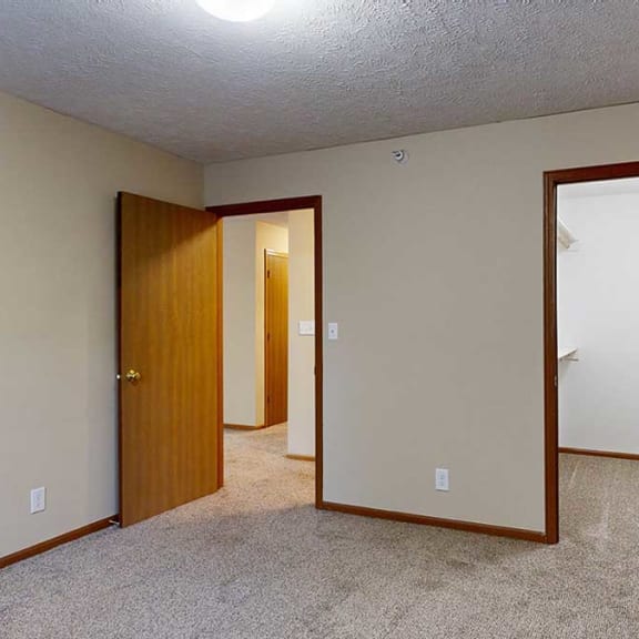 Thumbnail 15 of 20 a bedroom with an attached large walk-in closet