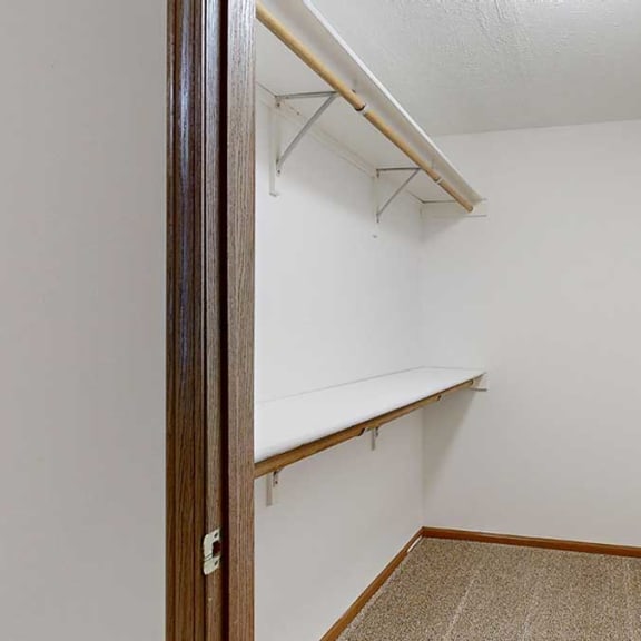 Thumbnail 17 of 20 a walk-in closet with built-in shelves and hanging space for ample storage