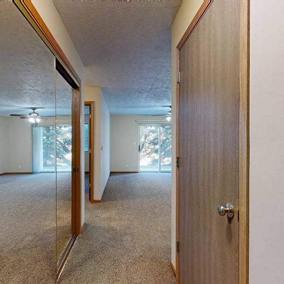 Thumbnail 2 of 20 an entryway hallway with a mirrored closet and a coat closet