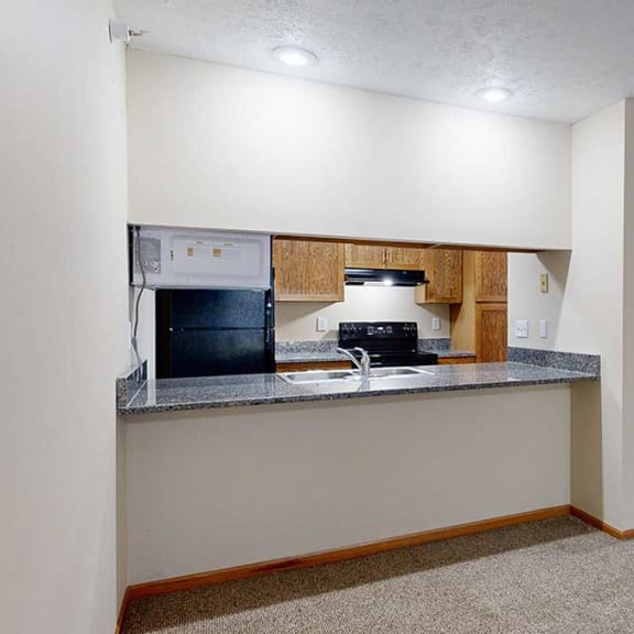 Thumbnail 10 of 20 a kitchen with a granite countertop breakfast bar