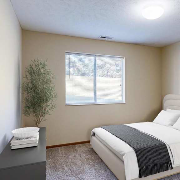 Thumbnail 8 of 29 A bedroom with a large bed and a lamp on the nightstand.