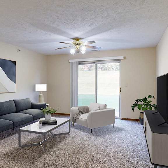 Thumbnail 2 of 29 An apartment living room with a navy sofa, a white armchair, a glass coffee table, and a television.
