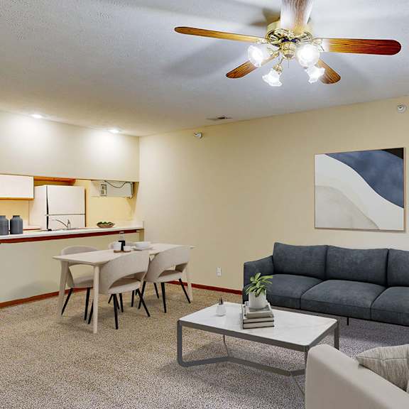 Thumbnail 3 of 29 A living room with a navy couch, a coffee table, and a ceiling fan.