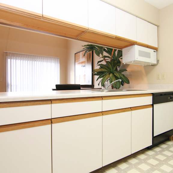 Thumbnail 6 of 13 Kitchen with peek through window under cabinets into the living room