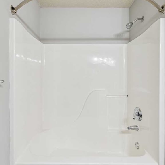Thumbnail 19 of 29 A white bathroom with a tub and shower.
