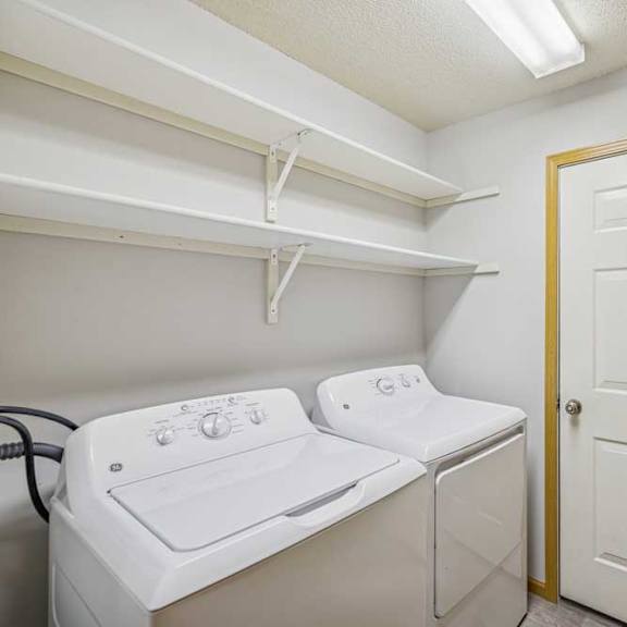 Thumbnail 29 of 29 A small laundry room with a washer and dryer.