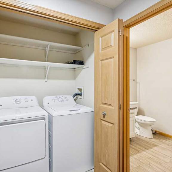 Thumbnail 12 of 13 A small laundry room with a washer and dryer.