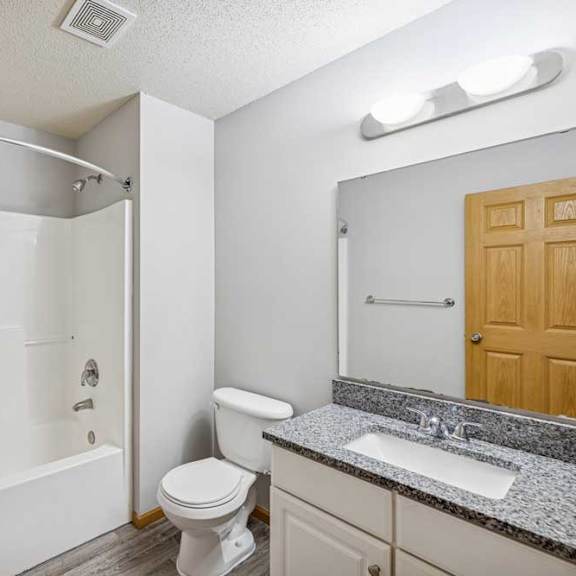 Thumbnail 40 of 40 A white bathroom with a toilet, sink, and shower.