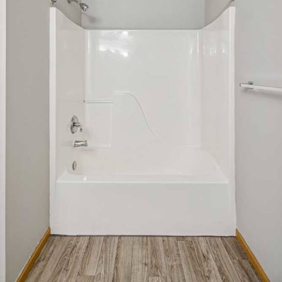 Thumbnail 34 of 40 A white bathroom with a walk-in shower.