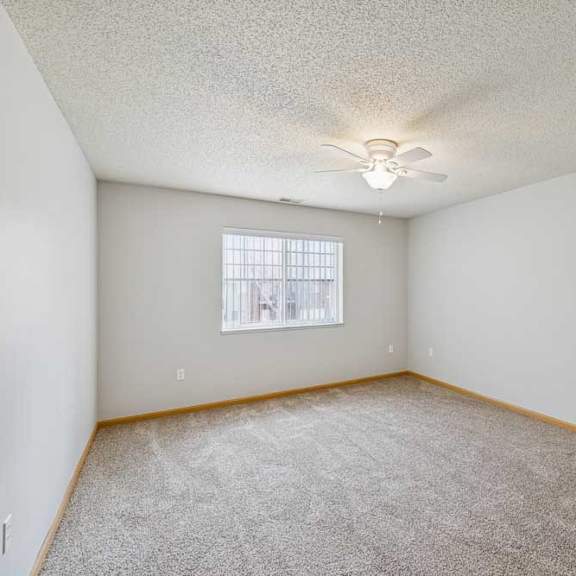 Thumbnail 29 of 40 A room with a ceiling fan and carpeted floor.