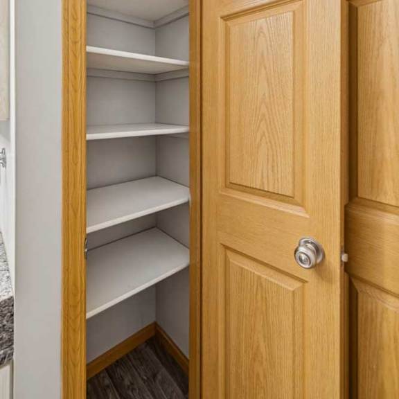 Thumbnail 35 of 40 A wooden door with a handle and shelves inside.