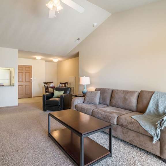 Thumbnail 3 of 20 A living room with a couch, chair, and coffee table.