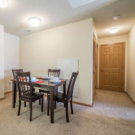 Thumbnail 6 of 20 A dining room with a table set for two.