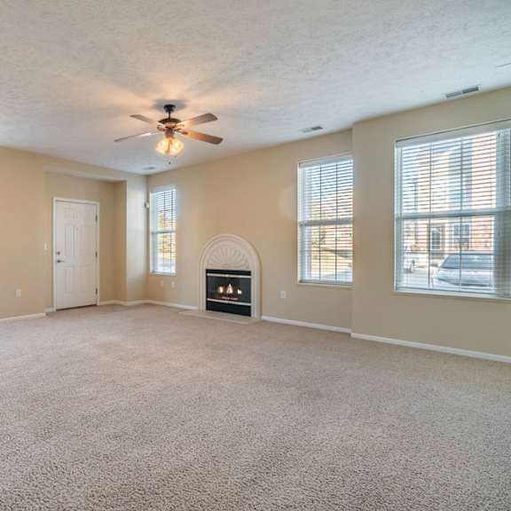 Thumbnail 3 of 16 large open living room with tons of windows and a fireplace
