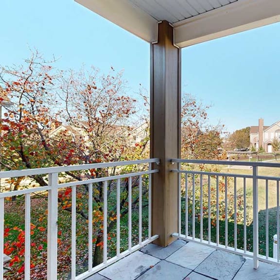 Thumbnail 14 of 28 a private balcony with a view of surrounding buildings and greenery