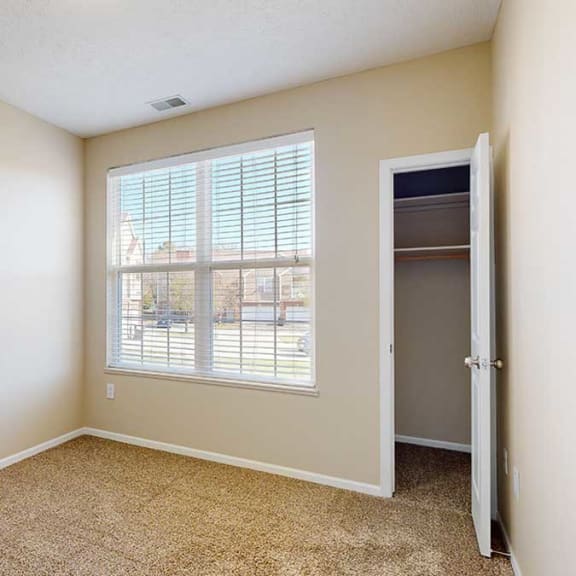 Thumbnail 21 of 28 a bedroom with a large double window and a closet