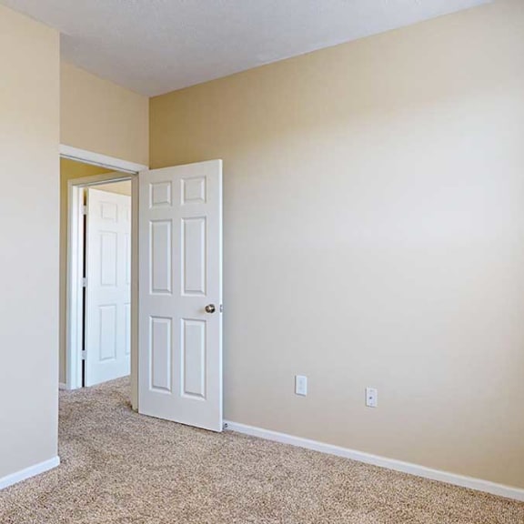 Thumbnail 24 of 28 a bedroom with a large window and a carpeted floor