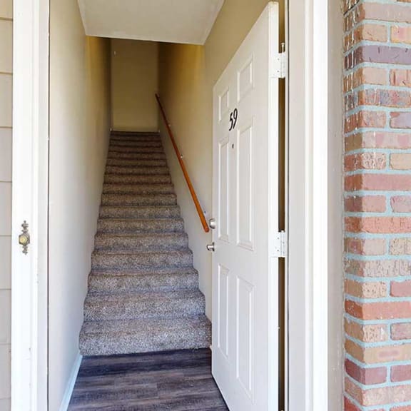 Thumbnail 2 of 28 a private entryway with a staircase leading to the upper level next to a door to the private attached garage