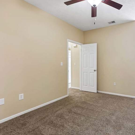 Thumbnail 32 of 34 A room with a ceiling fan and a window with blinds.
