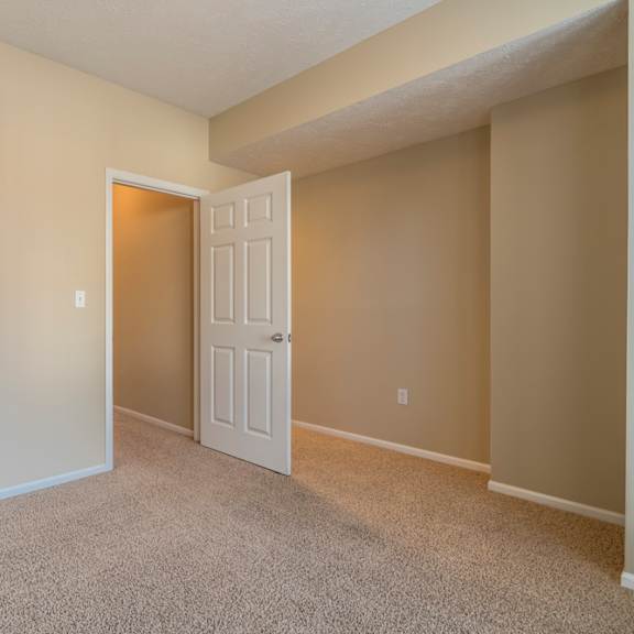 Thumbnail 16 of 16 A room with a white door and carpeted floor.
