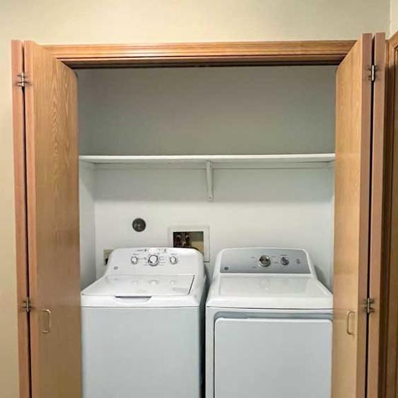 Thumbnail 8 of 11 a laundry closet with a washer and dryer in it