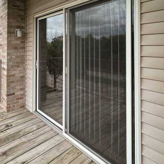 Thumbnail 11 of 24 a balcony with a sliding glass door and screen