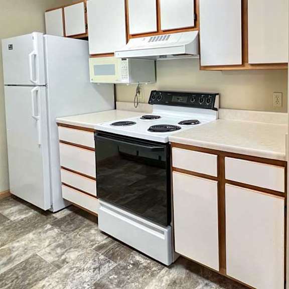 Thumbnail 8 of 24 a kitchen with white appliances, white and brown cabinets, and vinyl flooring