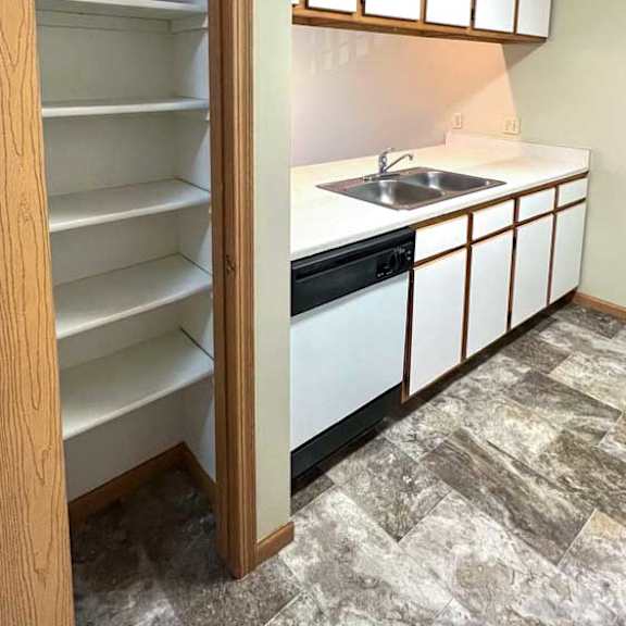 Thumbnail 6 of 24 a kitchen with white and brown cabinets and a pantry