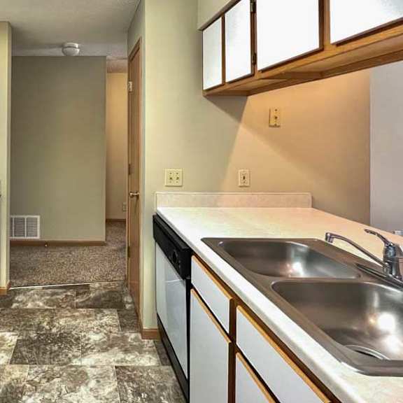Thumbnail 10 of 24 a kitchen with white appliances and white and brown cabinets