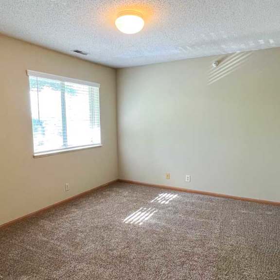 Thumbnail 6 of 9 a bedroom with a carpeted floor and a window