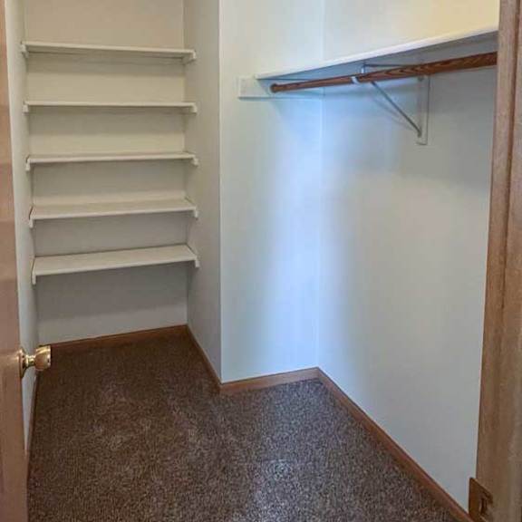 Thumbnail 7 of 9 a walk-in closet with built-in shelving and hanging space