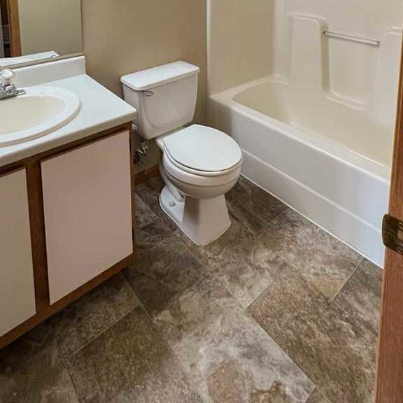 Thumbnail 8 of 9 a bathroom with a vanity sink, a towel rack, and a tub shower