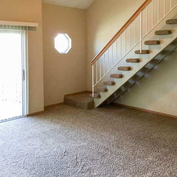 Thumbnail 19 of 24 a living room with a staircase leading up to the loft