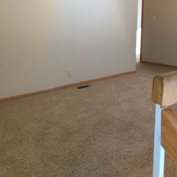 Thumbnail 21 of 24 a carpeted loft area with a small hallway leading to a bedroom and bathroom