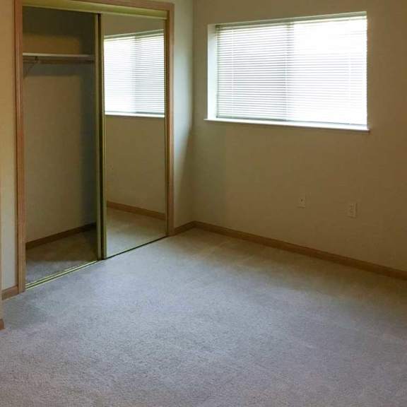 Thumbnail 11 of 11 a bedroom with a carpeted floor and a window with blinds