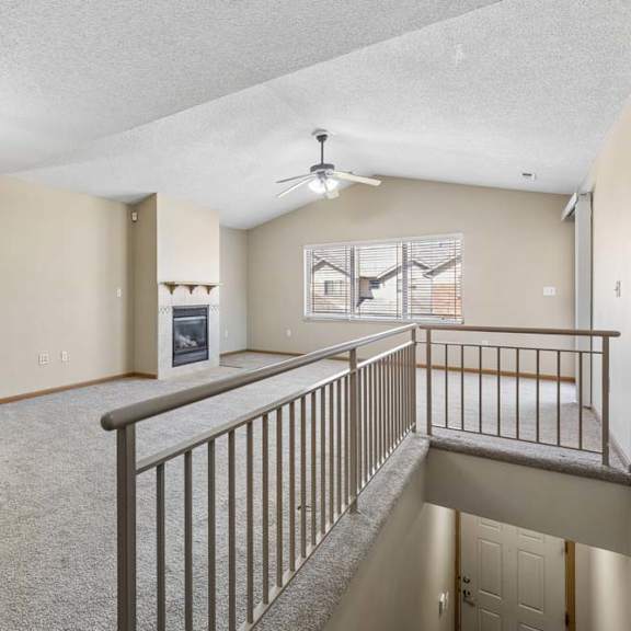 Thumbnail 31 of 38 Open-concept living area with fireplace, vaulted ceiling, and natural light.