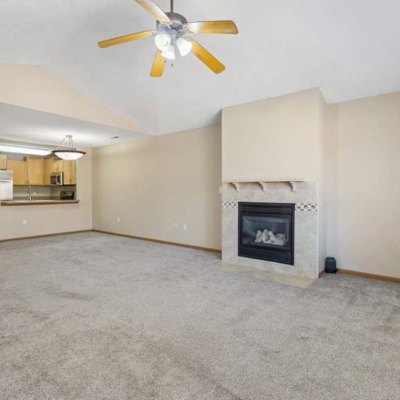 Thumbnail 32 of 38 Large living room with gas fireplace, vaulted ceilings, and open floor plan.