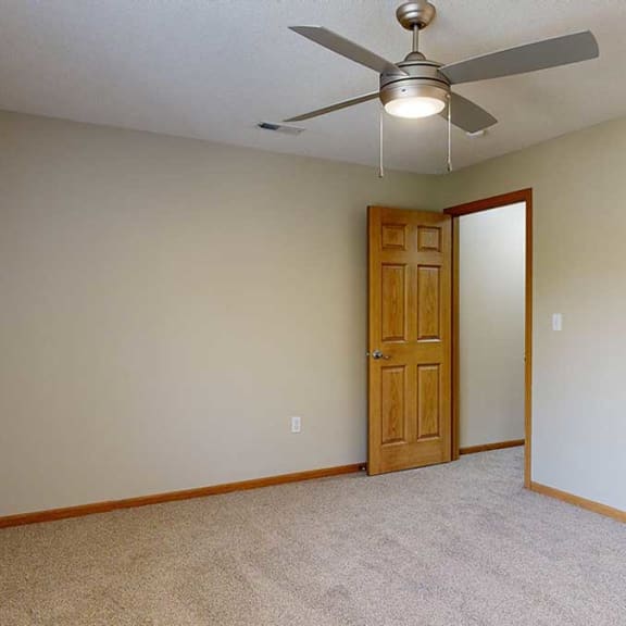 Thumbnail 19 of 26 a bedroom with a ceiling fan