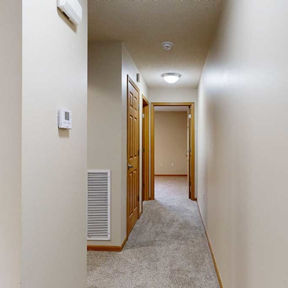 Thumbnail 18 of 26 a hallway with carpet and several doors