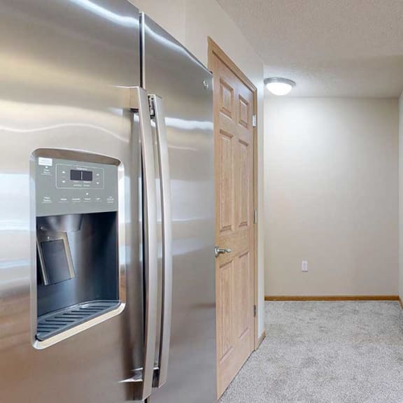 Thumbnail 17 of 26 a kitchen with a stainless steel refrigerator and a sink
