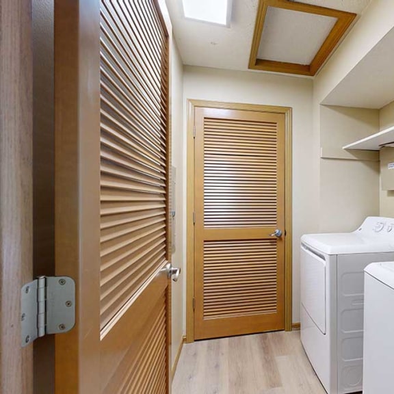 Thumbnail 24 of 26 a laundry room with a washer and dryer and a wooden door