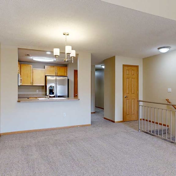 Thumbnail 12 of 26 a living room next to a kitchen and staircase with a closet at the top