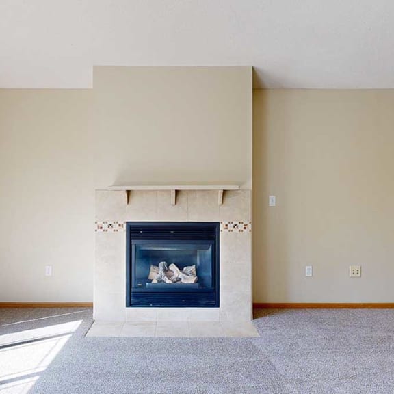 Thumbnail 8 of 26 a living room with a fireplace and mantle