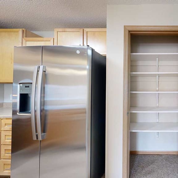 Thumbnail 16 of 26 a kitchen with a stainless steel refrigerator and a pantry