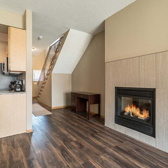 Thumbnail 5 of 21 Cozy fireplace and hardwood-style flooring at Southwind Villas in La Vista NE